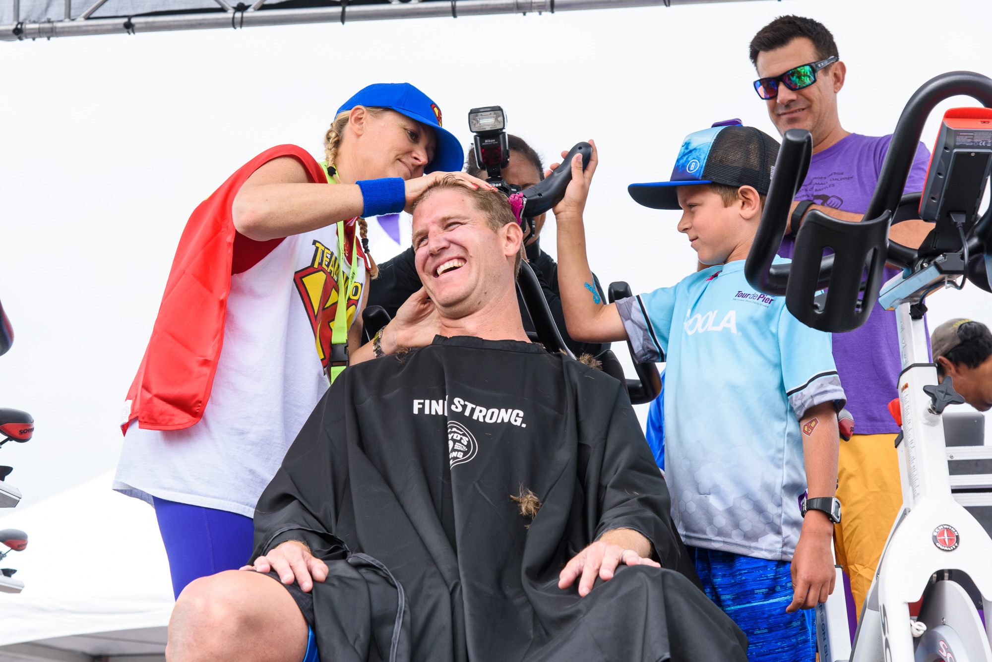Chinny helping to shave co-founder Heath's head to celebrate breaking $1 million fundraised in 2016!