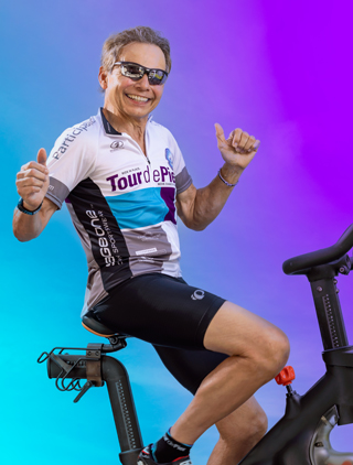Ed Langhammer dancing on a stationary cycling bike